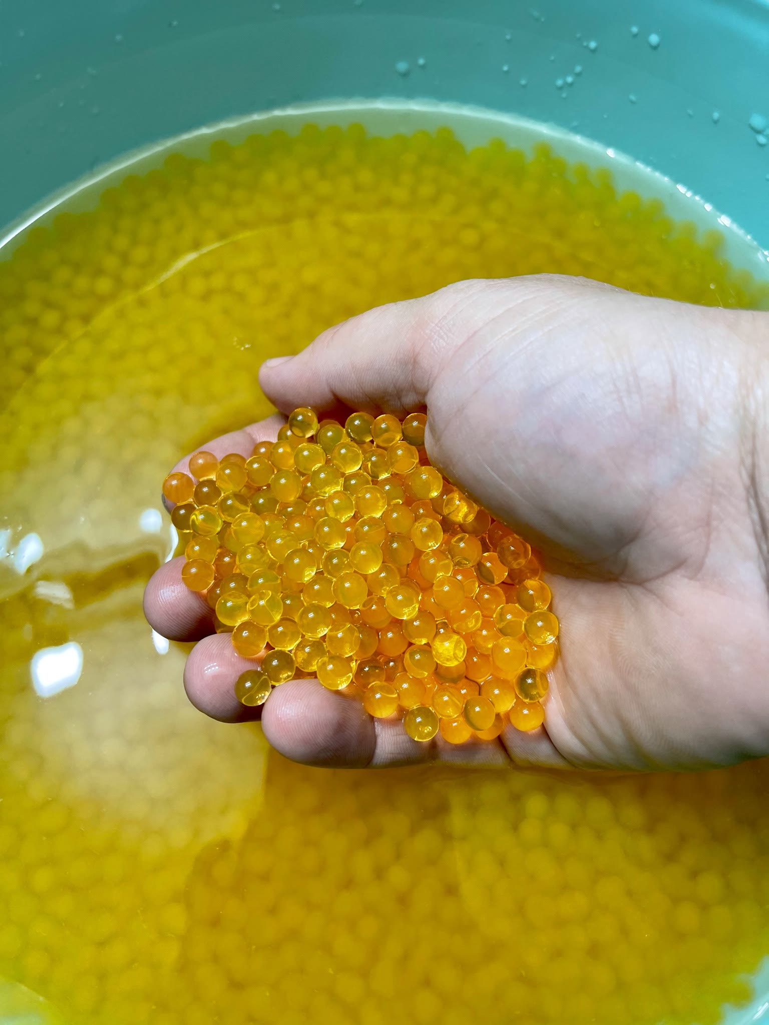 A handful of orange GellyBall beads