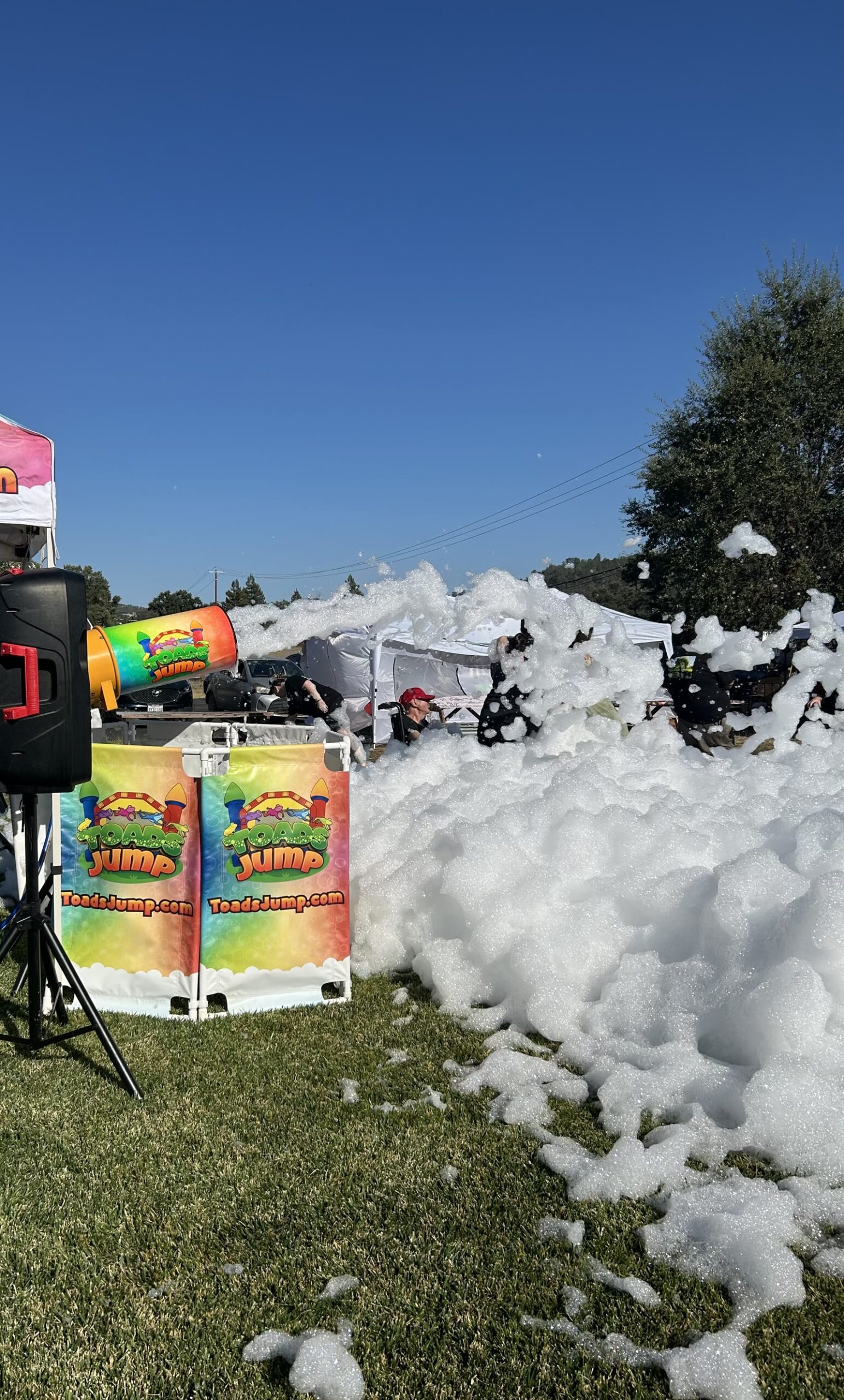Toads Jump foam party set up on the grass with a speaker and cannon
