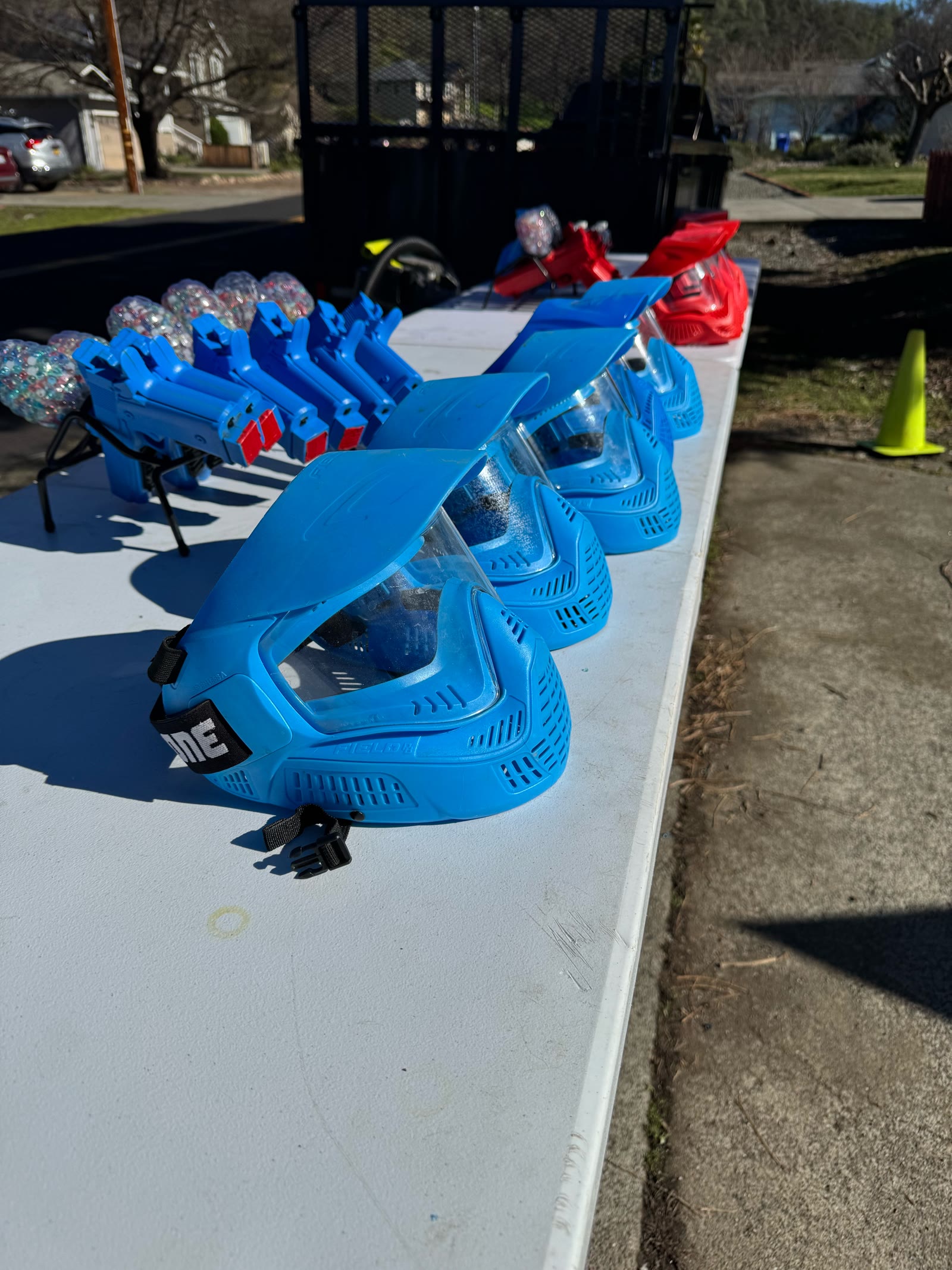 Blue GellyBall full face masks and blasters lined up on a table